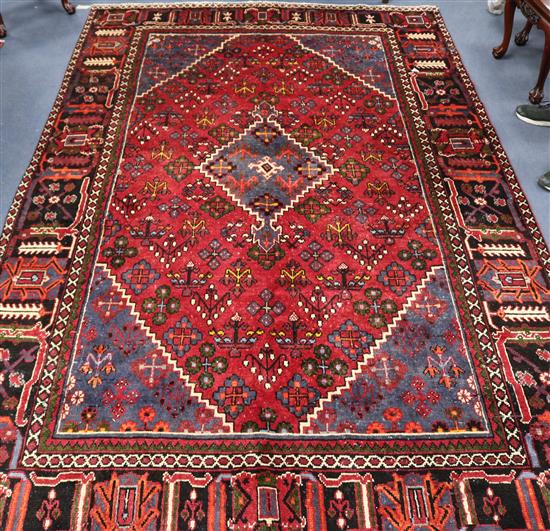 A Meimeh red and blue ground rug, 10ft 5in by 6ft 7in.